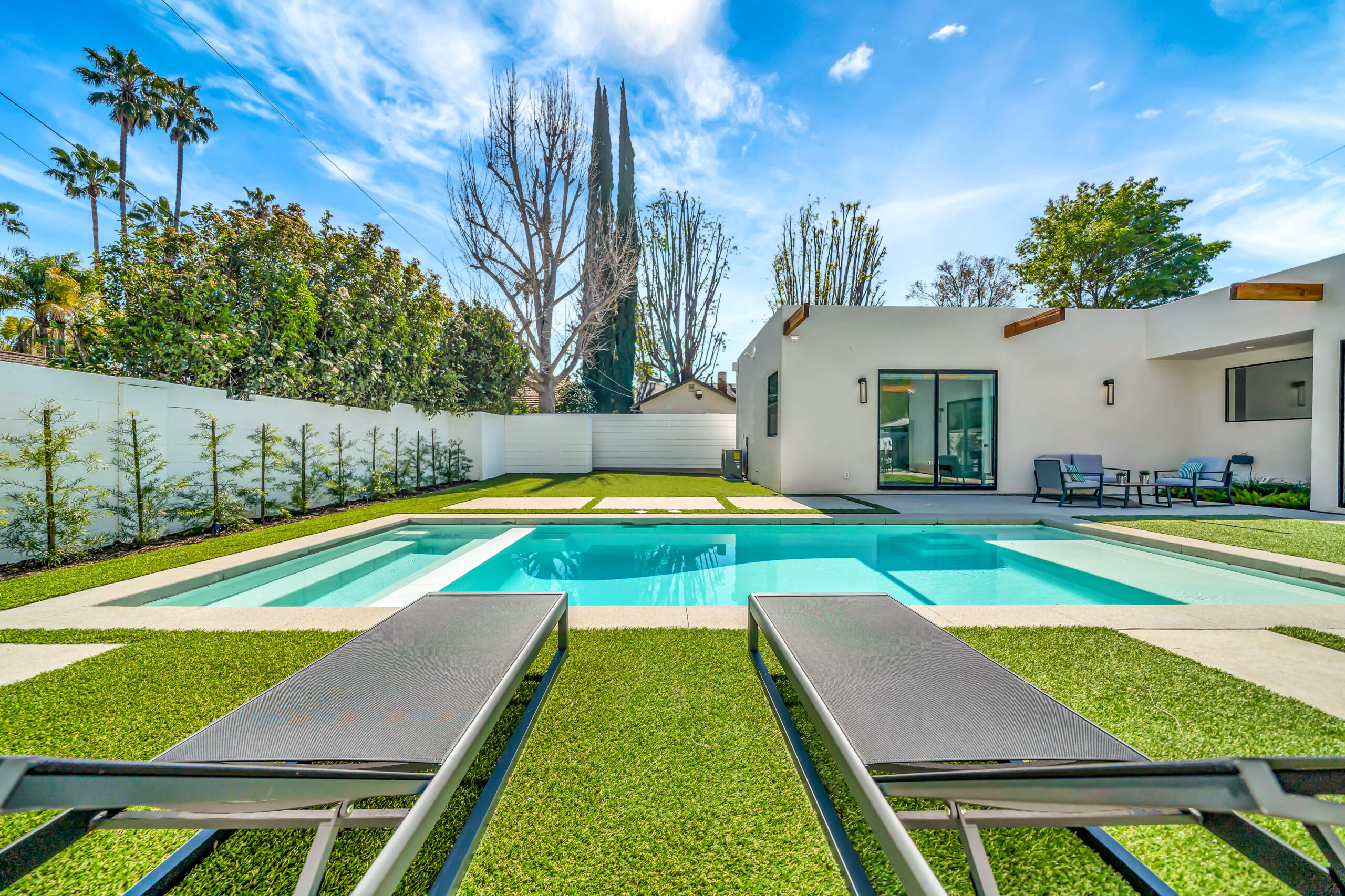 backyard pool and hot tub, with loungers